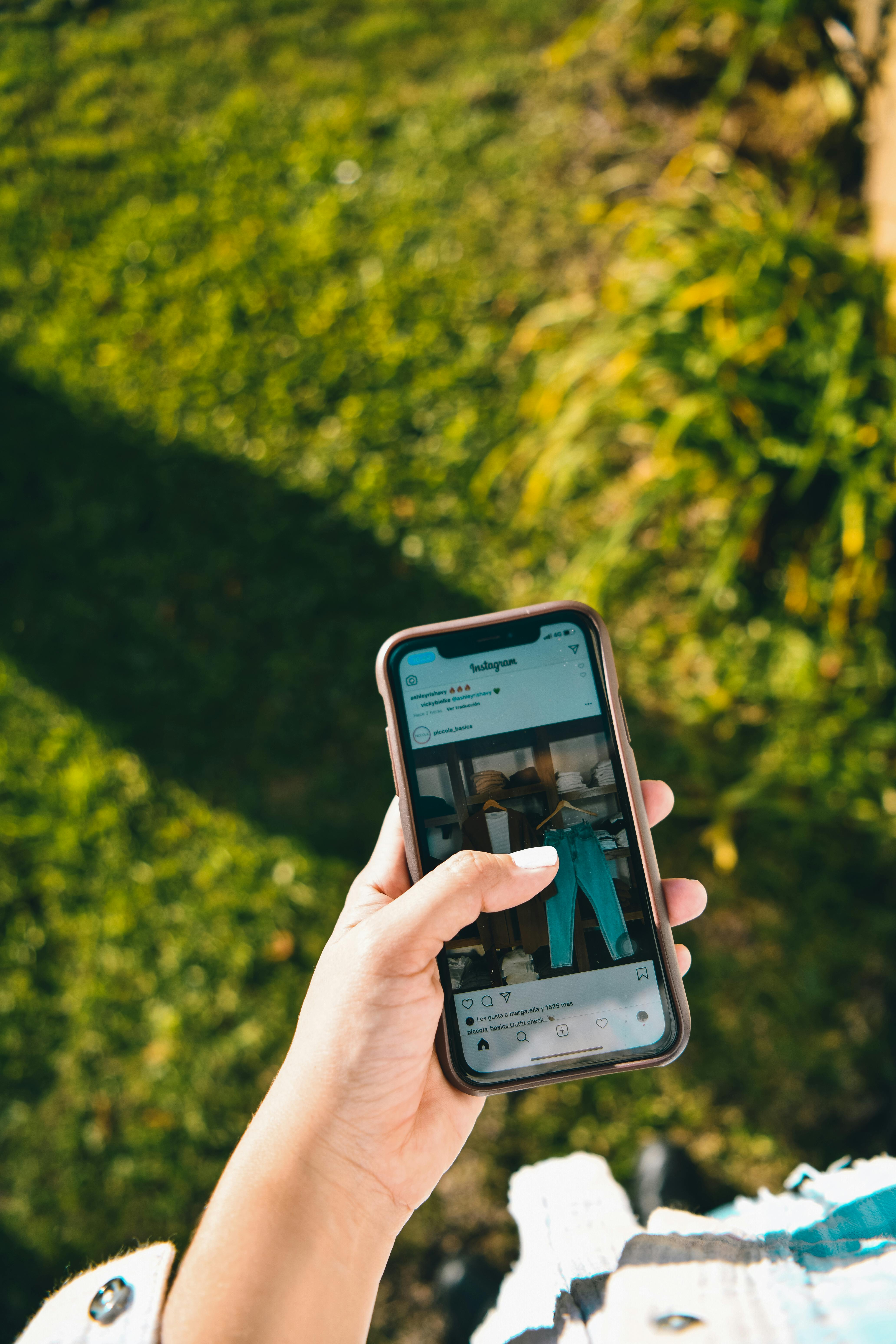 Person holding phone with Instagram open